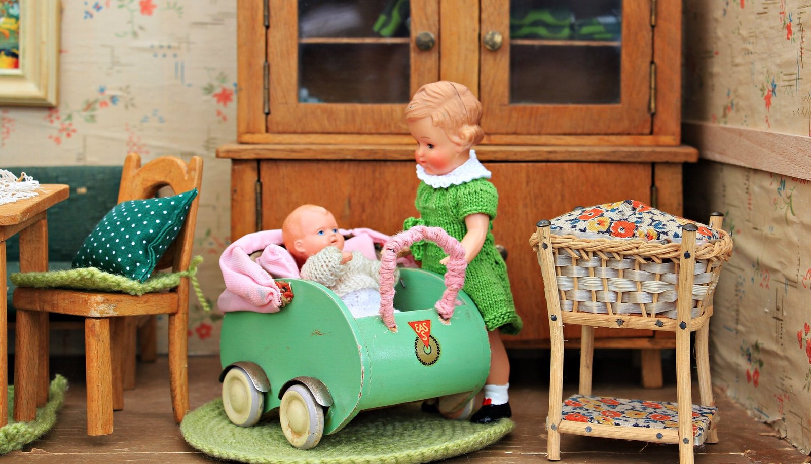 Brown Haired Girl Doll Holding Baby in Bassinet Doll